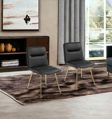 Set of Two Tufted Black And Gold Upholstered Faux Leather Dining Side Chairs