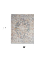 5' x 8' Ivory and Blue Oriental Power Loom Distressed Area Rug With Fringe