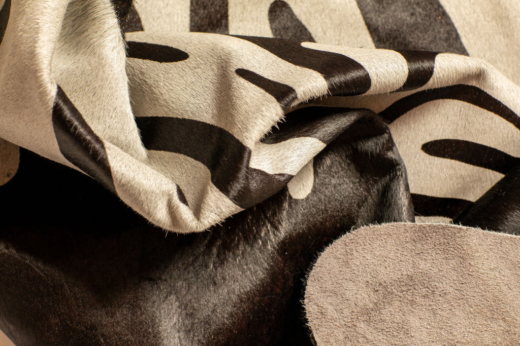 5' x 7' Black and Off White Cowhide Hand Knotted Area Rug