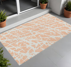 3' X 5' Peach and Ivory Abstract Washable Non Skid Indoor Outdoor Area Rug