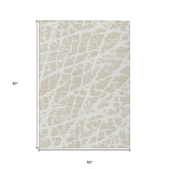 5' X 8' Beige and Ivory Abstract Washable Non Skid Indoor Outdoor Area Rug
