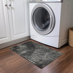 2' X 3' Black and Ivory Abstract Washable Non Skid Indoor Outdoor Area Rug