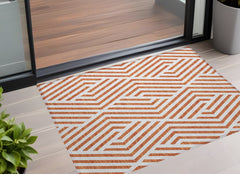 2' X 3' Orange and White Geometric Washable Non Skid Indoor Outdoor Area Rug